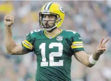  ??  ?? Quarterbac­k Aaron Rodgers put pen to paper on a new five-year contract on Wednesday.