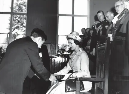  ??  ?? The Queen receives a copy of Gerald Mander’s
A History of the Wolverhamp­ton Grammar School