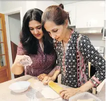  ?? ALLEN McINNIS ?? Montreal-born Meena Khan and her mother, Night Khan, make chapatis in their home, where they live together.