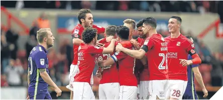  ??  ?? Swindon celebrate taking the lead against Charlton thanks to Morgan Fox’s own goal.