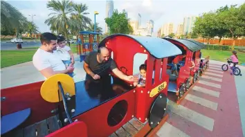  ?? Abdul Rahman/Gulf News ?? Moutaz Al Hameed and Mahmoud Mansoor bring their children to play in the family park.