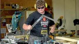  ?? WARWICK SMITH/ STUFF ?? Harrison Gillard gets to work building his technicall­y challengin­g picnic table.