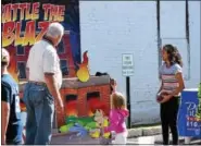  ?? MARIAN DENNIS — DIGITAL FIRST MEDIA ?? Battle the Blaze was one of many games featured during Royersford Community Day. Kids had to throw balls at the stand-up flames in order to knock them down.