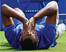  ??  ?? Heartache: Kyrgios is down and out after slipping at Queen’s