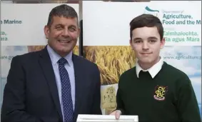  ??  ?? Pierce Ryan from FCJ Bunclody receives his certificat­e from Minister of State for the Department of Agricultur­e, Food and the Marine, Andrew Doyle.