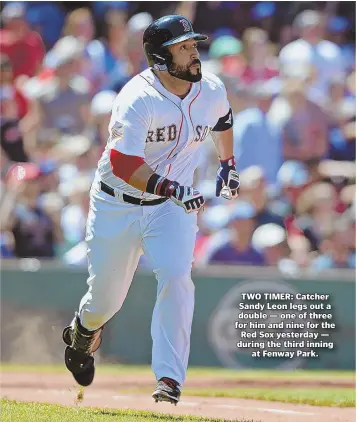  ?? STAFF PHOTO BY CHRISTOPHE­R EVANS ?? TWO TIMER: Catcher Sandy Leon legs out a double — one of three for him and nine for the Red Sox yesterday — during the third inning at Fenway Park.