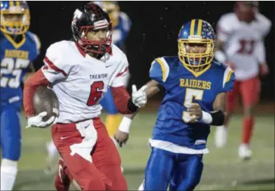  ?? JOHN BLAINE — FOR THE TRENTONIAN ?? Trenton’s James Hubbard (6) outruns North Brunswick’s Brandon Outlaw (5) to score a touchdown on a kickoff return during a first round Central Group V game on Friday night.