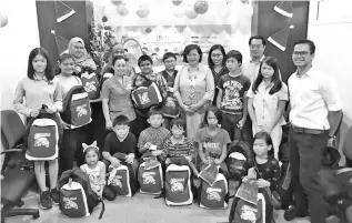  ??  ?? Lasimbang (standing, eighth left) at the handing over ceremony held in the MAA Medicare Charity Dialysis Centre Kota Kinabalu yesterday.