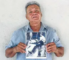  ?? Jud Esty-Kendall / StoryCorps / Associated Press ?? Juan Romero holds a photo of himself and the dying Sen. Robert F. Kennedy, taken by the Los Angeles Times’ Boris Yaro on June 5, 1968.