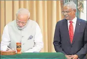  ?? AFP ?? ■ PM Modi signs a guestbook during Maldives President Ibrahim Solih's presidenti­al inaugurati­on in Male, Maldives, Saturday.