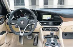  ??  ?? USER FRIENDLY: All the main controls, including the start button, are incorporat­ed in the steering wheel. The human-machine interface consists of two simple, user-friendly knobs for adjusting the Alfa DNA selector and the infotainme­nt system