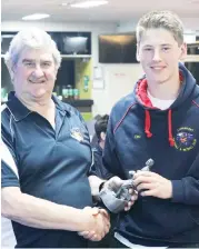  ??  ?? EDFL board of management chair Roger Gwynne presents the under 16 leading goal kicker award to Angus Adamiak of Longwarry.