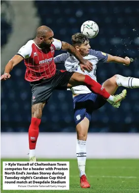  ?? Picture: Charlotte Tattersall/Getty Images ?? Kyle Vassell of Cheltenham Town competes for a header with Preston North End’s Jordan Storey during Tuesday night’s Carabao Cup third round match at Deepdale Stadium