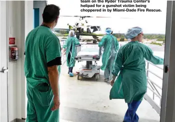  ?? LILLY ECHEVERRIA ?? Miami trauma surgeon George Garcia, on facing page and at left, waits with his team on the Ryder Trauma Center’s helipad for a gunshot victim being choppered in by Miami-Dade Fire Rescue.