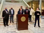  ?? Beau Evans, Capitol Beat ?? Gov. Brian Kemp (at podium), unveiled $1,000 bonuses for state employees on Wednesday while flanked by Georgia House Speaker David Ralston (left), Lt. Gov. Geoff Duncan (right) and top-ranking General Assembly lawmakers.