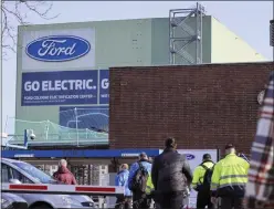  ?? ALEX KRAUS — BLOOMBERG ?? Employees arrive for work at the Ford Motor Co. plant in Cologne, Germany, on Tuesday, Feb. 14, 2023. Ford will dismiss some 11% of its workforce in Europe in the latest sign of industrial disruption caused by the automotive sector’s shift to electric vehicles.