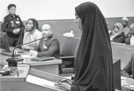  ?? JORDAN LAIRD/ COLUMBUS DISPATCH ?? Shukri Hassan, right, the daughter of Imam Mohamed Hassan Adam, speaks Tuesday at the sentencing of 24-year-old Isaiah Brown-miller (seated at left) in Franklin County Common Pleas Court for kidnapping and aggravated robbery in connection with the death of her father, Imam Mohamed Hassan Adam, in 2021.