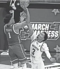  ?? MARC LEBRYK/USA TODAY SPORTS ?? Drake’s Joseph Yesufu shoots against Wichita State’s Alterique Gilbert (3) in the second half of Drake’s 53-52 win.