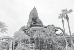  ?? KATHLEEN CHRISTIANS­EN/ORLANDO SENTINEL ?? Guests ride slides down four lanes through underwater sea caves on Punga Racers, an attraction at Universal’s Volcano Bay.