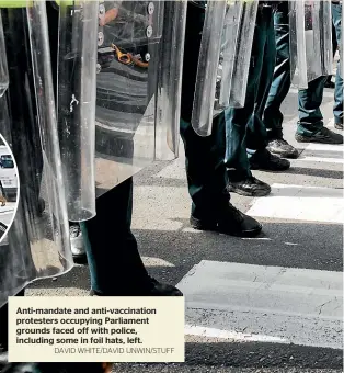  ?? DAVID WHITE/DAVID UNWIN/STUFF ?? Anti-mandate and anti-vaccinatio­n protesters occupying Parliament grounds faced off with police, including some in foil hats, left.