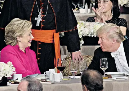  ??  ?? Presidenti­al nominees Hillary Clinton and Donald Trump share a moment after speaking during the Alfred E Smith Memorial Foundation Dinner for charity