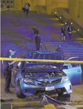  ?? STAFF PHOTO BY NICOLAUS CZARNECKI ?? MISSTEP: An allegedly drunken Rhode Island driver was arrested after fleeing from this Toyota Corolla that cops say he drove down three flights of stairs at City Hall. Police reported finding an open bottle of whisky and a gun inside the vehicle.