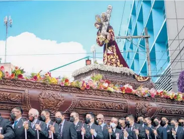  ?? JOHAN ORDONEZ/GETTY-AFP ?? Holy Week procession: An image of Jesus is carried by Catholic faithful as they take part in La Resena procession Tuesday during Holy Week in Guatemala City. The procession began early in the morning with parishione­rs carrying a multitude of religious images and statues or bouquets of flowers. Good Friday and Easter are in a few days.