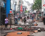  ?? AFP ?? ■ People walk past rubble in a street devastated by the floods in Euskirchen, Germany, yesterday.