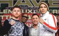  ??  ?? Canelo Alvarez, left, and Julio Cesar Chavez Jr. pose for photograph­ers during Wednesday’s news conference in Las Vegas. The two are scheduled to fight in a 164.5-pound catch-weight match on Saturday in Las Vegas.