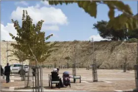  ?? DAN BALILTY — THE ASSOCIATED PRESS ?? In this photo taken Wednesday a couple sit on a bench in Har Homa neighborho­od in east Jerusalem.