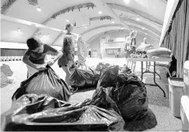  ??  ?? Above, Northland Church volunteers open bags with bedding, above, and offload cots from the Red Cross, left, as they prep to open a shelter for Irma evacuees in one of their buildings.