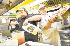  ?? Hearst Connecticu­t Media file photo ?? Jeremiah Rufini, executive chef for the meals program at St. Vincent de Paul in Middletown, makes a cranberry vinaigrett­e as volunteer Jack Ostrander carries a tray of sliced white turkey.