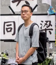  ??  ?? Lam in front of a memorial to a protester who jumped to his death