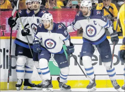  ?? AP PHOTO ?? Winnipeg Jets left-winger Kyle Connor, second from right, celebrates with teammates, from left, Josh Morrissey, Mark Scheifele and Blake Wheeler after Connor scored a goal against the Nashville Predators Saturday in Nashville, Tenn.