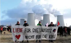  ?? Photograph: Christian Mang/Reuters ?? Climate activists in front of the coal-fired Jaenschwal­de power station in the Lausitz region, Germany, protesting against open-cast mining in November 2019. Their banner reads: ‘Love for the Lausitz. Not for the coal.’