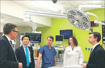  ?? Johns Hopkins Medicine ?? DRS. GERALD Brandacher, from left, W.P. Andrew Lee and Richard Redett, Carisa Cooney, an assistant professor of plastic and reconstruc­tive surgery, and Dr. Damon Cooney discuss the genital transplant.