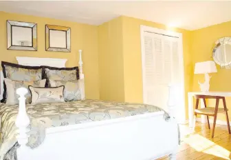  ??  ?? Yellow helps perk up this relatively small vacation-home bedroom. Other colours to consider include charcoal grey and cool blue, a calming colour that helps make a space feel relaxing.