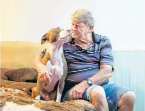  ?? JACOB LANGSTON/STAFF PHOTOGRAPH­ER ?? Robert L. Brady and his dog Bane, a 4-year-old mixed-breed, share a cuddle Wednesday. Bane could be trained to become a service dog so he can stay with Brady; a condo associatio­n has ordered him to give up Bane or move out. In a new wrinkle, Brady has been elected to the board.