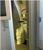  ??  ?? A passenger on an Air New Zealand flight saw crew hanging a laundry bag on an emergency door handle.