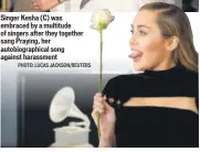  ?? PHOTO: ANDREW KELLY/REUTERS ?? Singer Miley Cyrus posing with a white rose stem, symbolisin­g equal representa­tion in the workplace