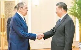  ?? LI XUEREN/XINHUA NEWS AGENCY ?? Russian Foreign Minister Sergey Lavrov, left, and Chinese President Xi Jinping meet Tuesday at the Great Hall of the People in Beijing.