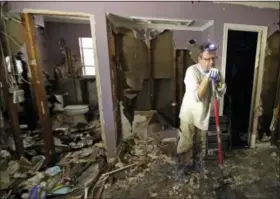  ?? DAVID J. PHILLIP — THE ASSOCIATED PRESS ?? Edward Woods takes a break from cleaning up his mother’s home, which was destroyed by floodwater­s in the aftermath of Hurricane Harvey, Sunday in Spring, Texas.