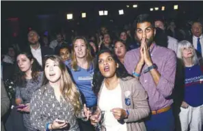  ??  ?? People react to the election results during a Democratic Congressio­nal Campaign Committee election watch party at the Hyatt Regency in Washington, DC yesterday.