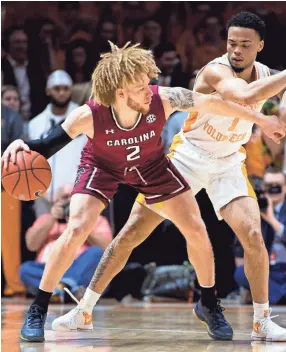  ??  ?? Tennessee guard Lamonte Turner (1) plays defense against South Carolina’s Hassani Gravett (2) on Wednesday. BRIANNA PACIORKA/NEWS SENTINEL