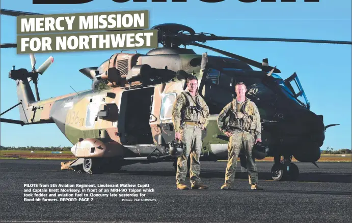  ?? Picture: ZAK SIMMONDS ?? PILOTS from 5th Aviation Regiment, Lieutenant Mathew Cupitt and Captain Brett Morrissey, in front of an MRH-90 Taipan which took fodder and aviation fuel to Cloncurry late yesterday for flood-hit farmers.