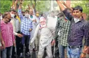  ??  ?? From L: Congress workers hold an effigy of PM Modi and raise slogans during a protest against the Centre over its raids; cops stand guard outside the Amarpali office of Rajiv Arora, member of State Congress office, in Jaipur on Monday. —ANI