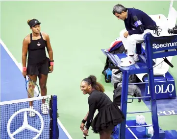  ??  ?? Naomi Osaka of Japan, Serena Williams of the United States and chair umpire Carlos Ramos talk after Ramos charges Williams with a game penalty in the second set in the women’s final at USTA Billie Jean King National Tennis Center. — USA TODAY SPORTS photo