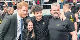  ??  ?? Royal comfort... family of tragic Kim Briggs, left, were consoled by Prince Harry at a military rugby match in April, right