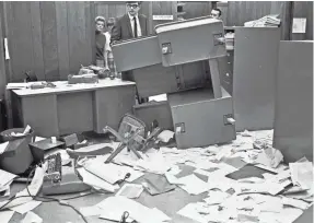  ?? OSHKOSH NORTHWESTE­RN FILE PHOTO ?? Officials look over some of the damage that was part of the Black Thursday demonstrat­ion on Nov. 21, 1968, at State University of Wisconsin at Oshkosh — now the University of Wisconsin-Oshkosh. UW-Oshkosh held Black Thursday Remembered 50 years later Wednesday.