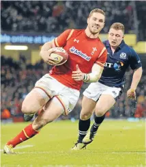  ??  ?? George North darts away for Wales’ crucial second-half try in their 27-23 win against Scotland in Cardiff.
PHOTO: REUTERS.